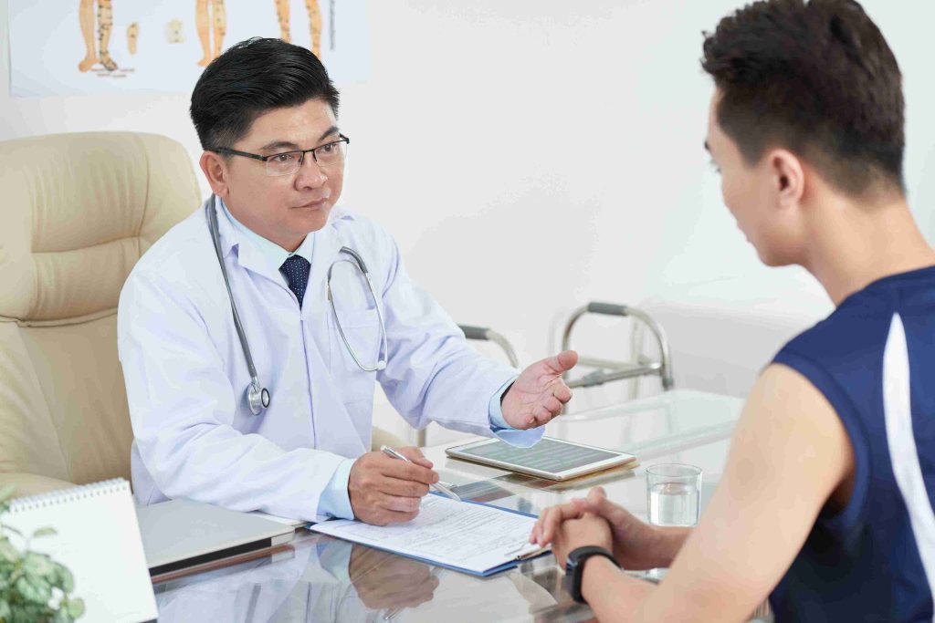 male doctor speaking with a male patient