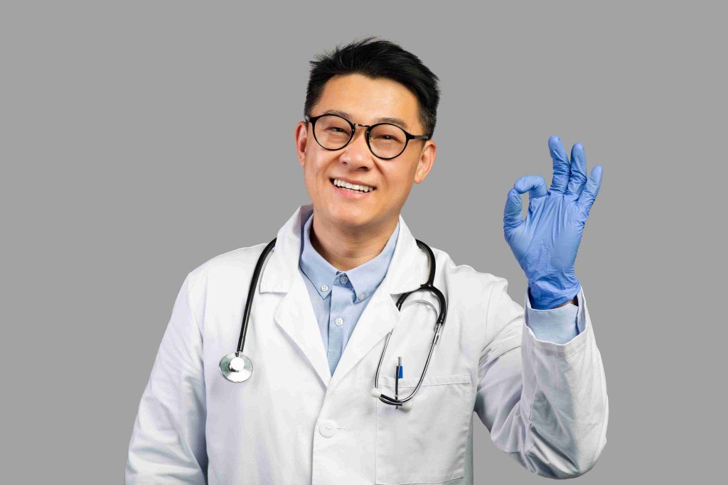 smiling doctor flashing the okay sign