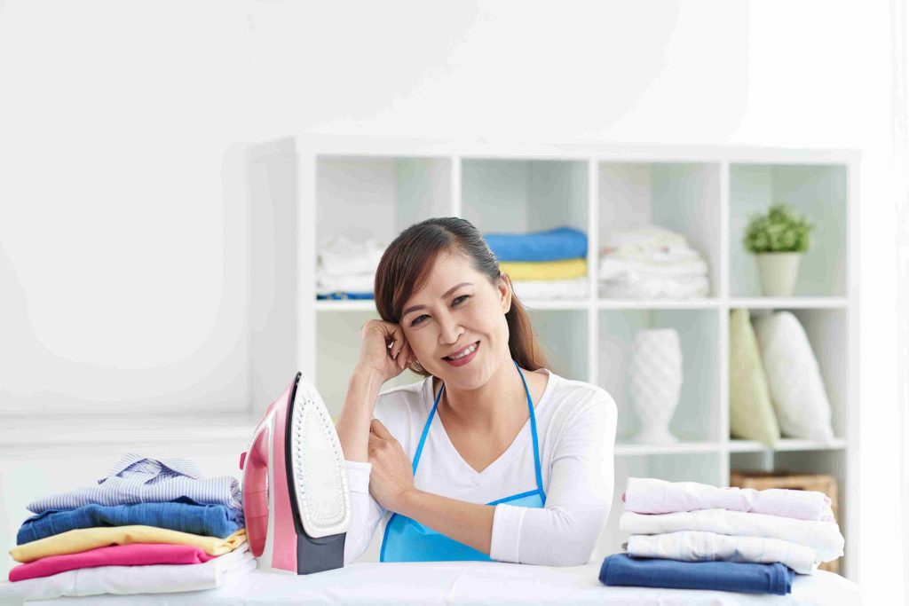 female domestic worker ironing clothes