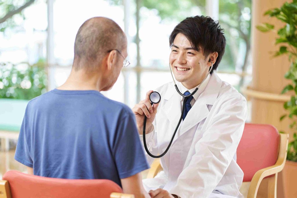 male doctor checking an elderly patient