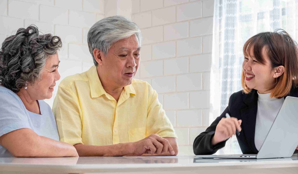 elderly couple getting advice from a female lawyer