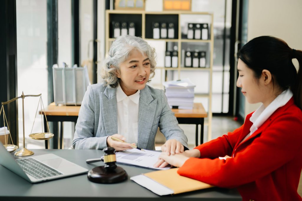 old woman speaking with a young female lawyer
