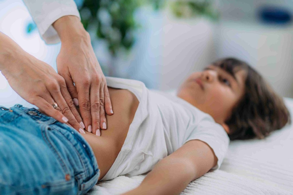 gastroenterologist examining a boy's stomach