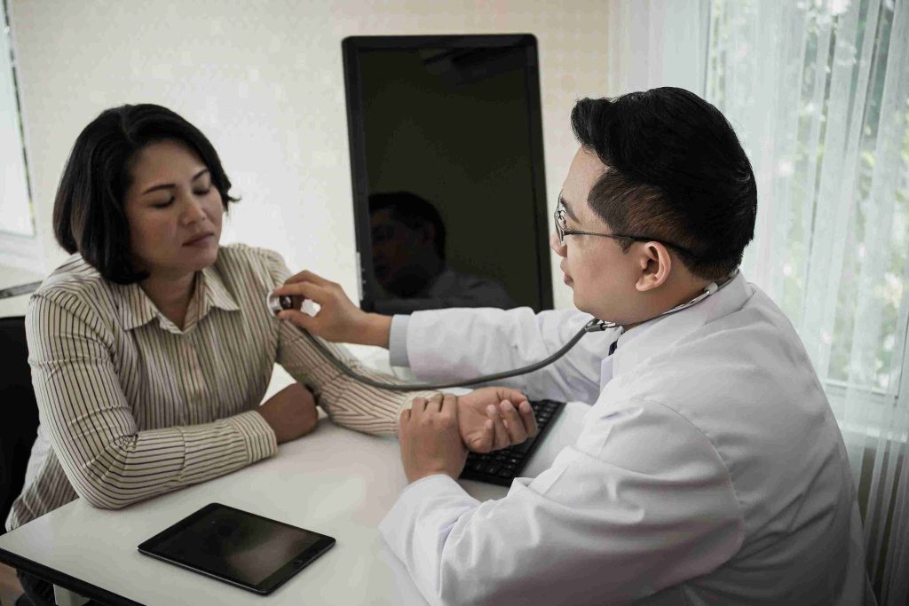 female worker examined by a doctor