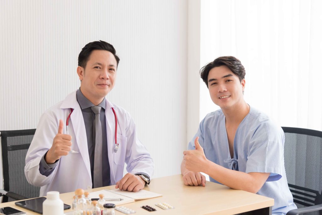 two male medical health workers smiling