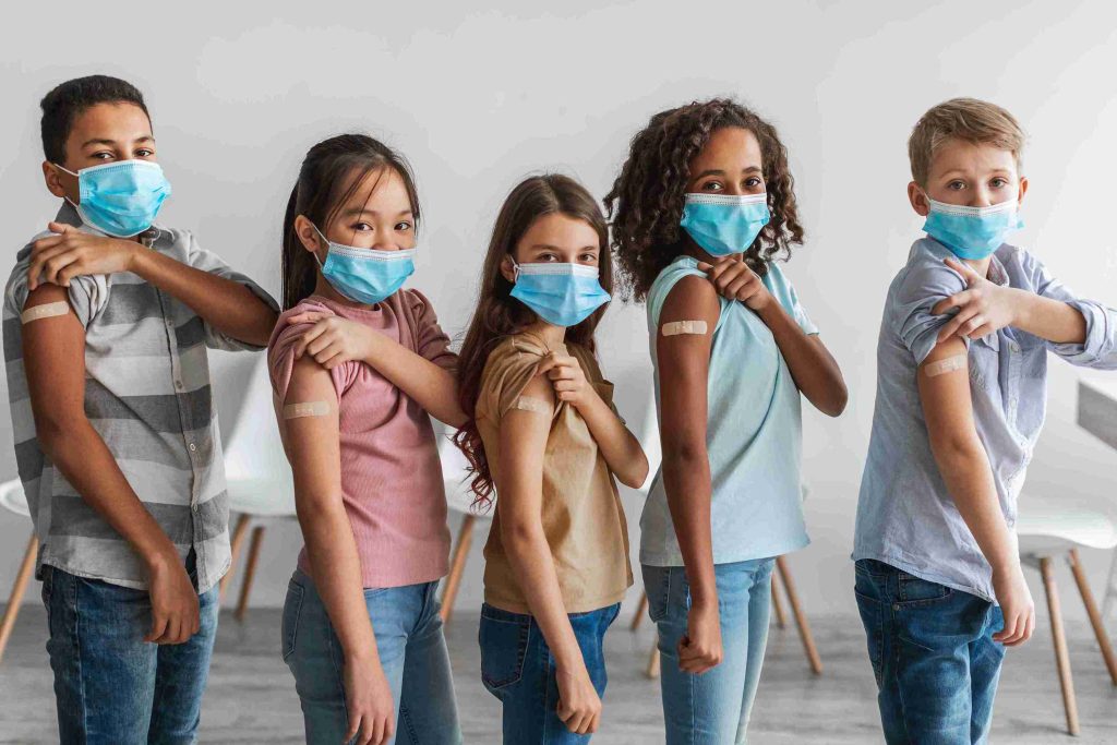children showing off their vaccination