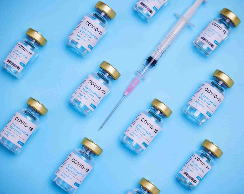 image of needle and COVID-19 vaccine vials