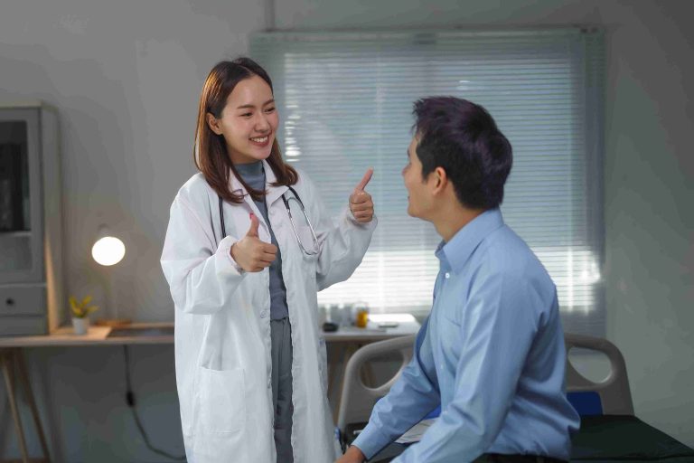 doctor giving her patient the thumbs up sign