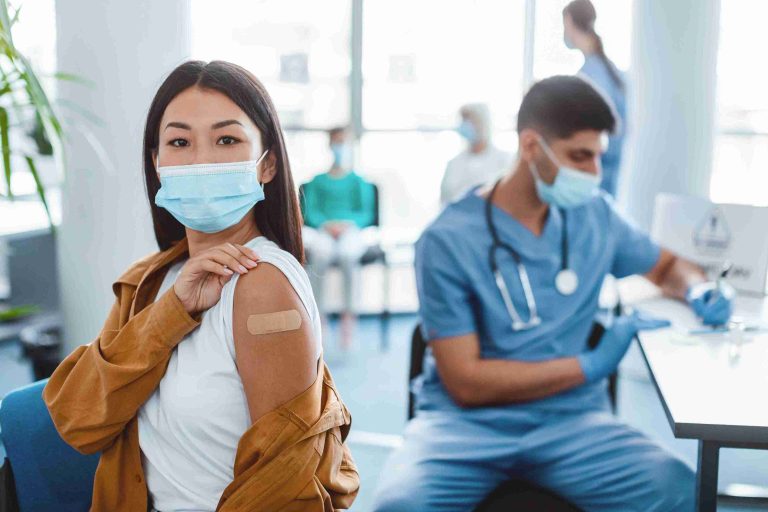 young woman showing her vaccinated arm