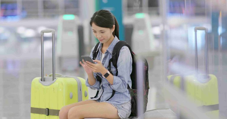woman using her cellphone in the airport