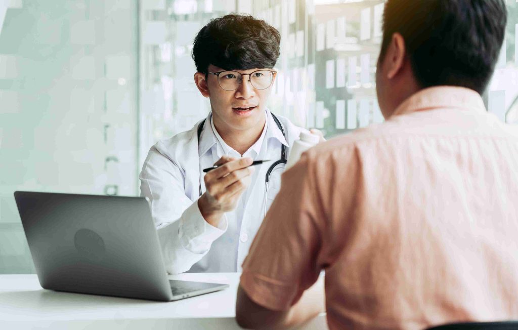 Young doctor explaining things to a male patient.