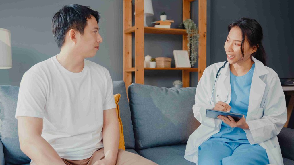 Male patient speaking with his doctor for consultation.