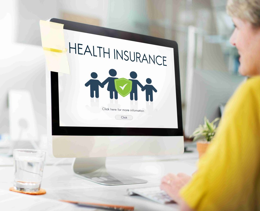 Healthcare worker checking insurance coverage online.