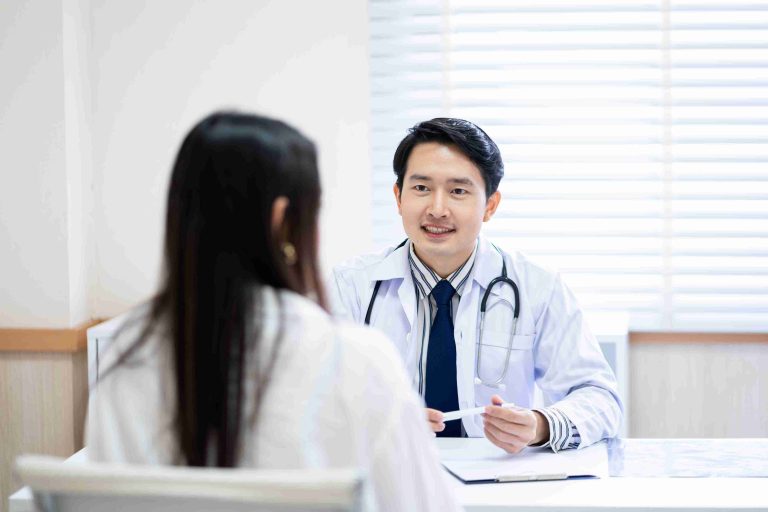 Doctor smiling and speaking with patient.