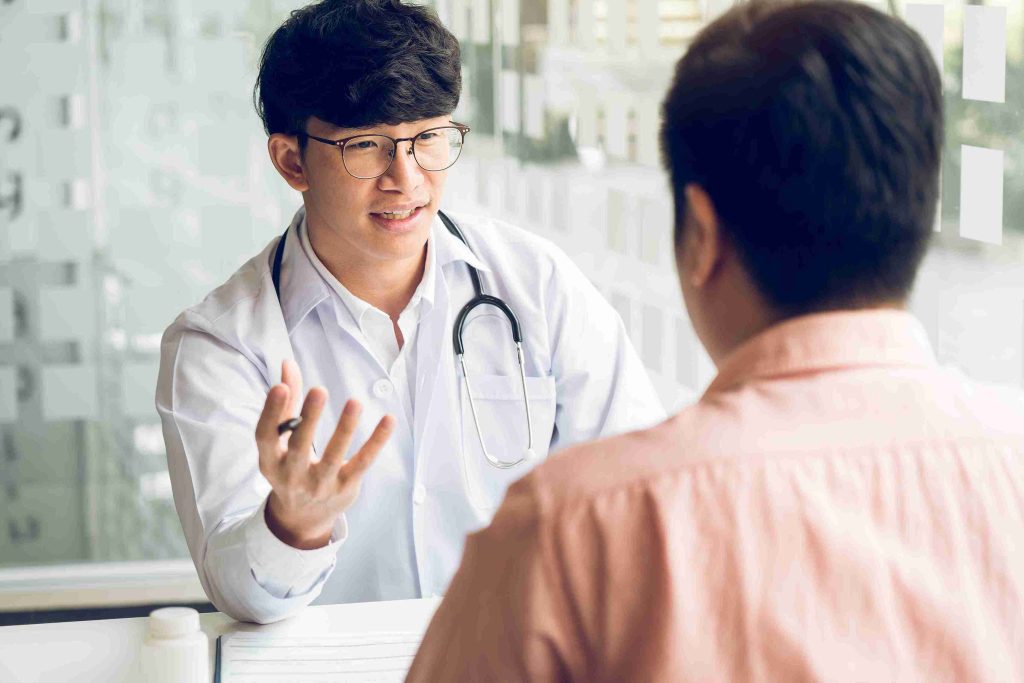 Young doctor speaking with a patient.