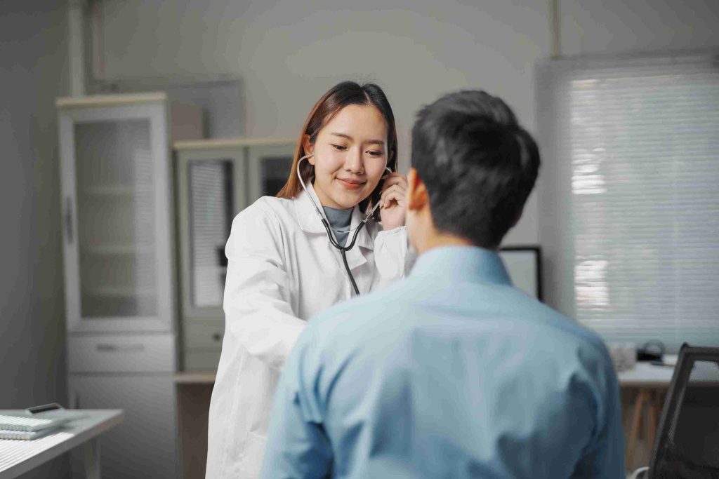 Female doctor checking a male patient.