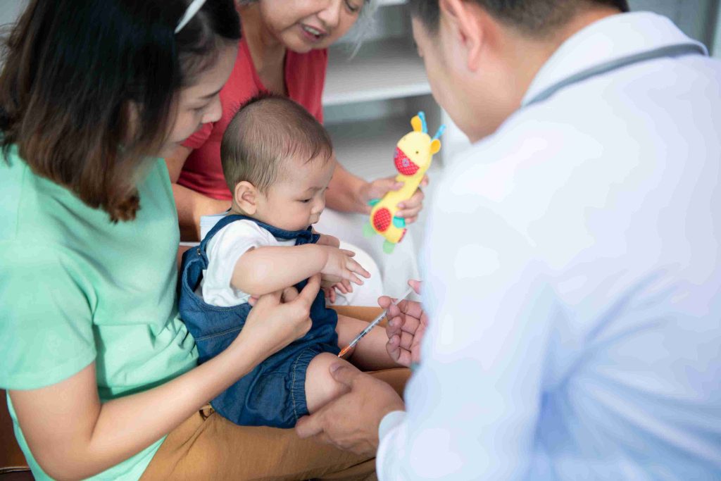 Infant given a vaccination by a doctor.