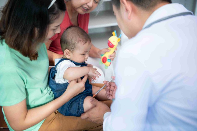 Infant given a vaccination by a doctor.
