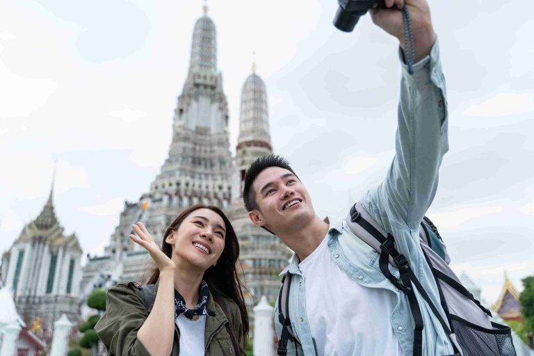 Asian couple taking pictures while travelling.