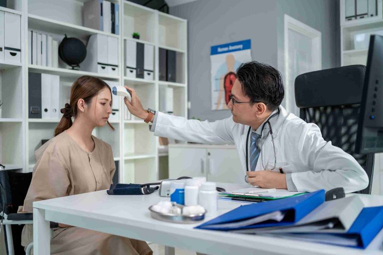 Doctor getting a patient's temperature.