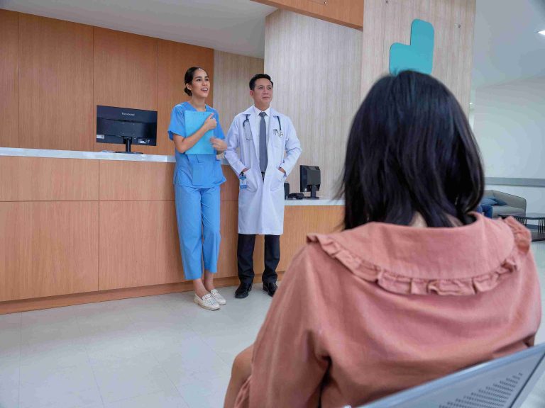 Doctor and nurse speaking with patients at the hospital.