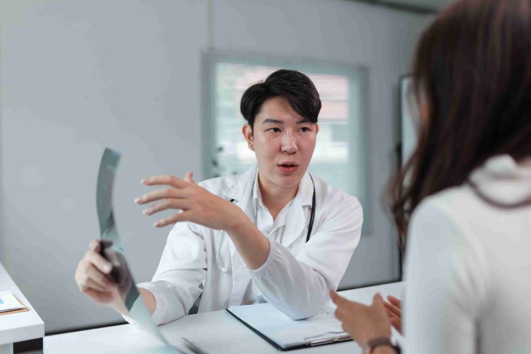 Young male doctor explaining something to a patient.