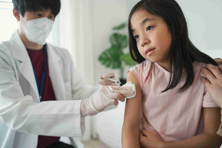 Asian child getting vaccinated.