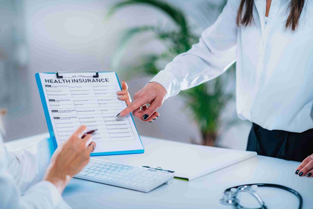 Healthcare workers processing health insurance.