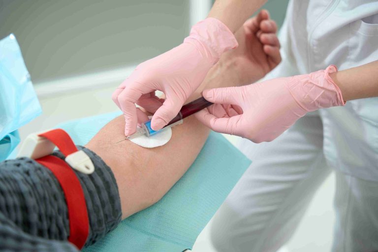 Health worker getting blood from a patient.