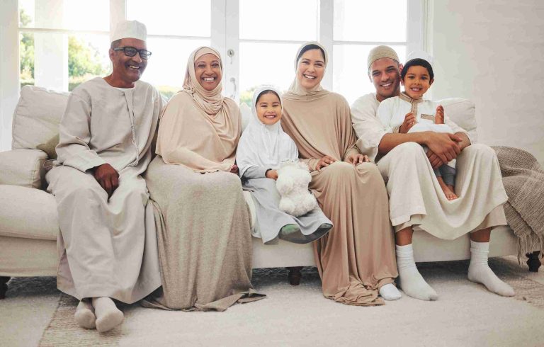 Portrait of a muslim family sitting in a sofa.