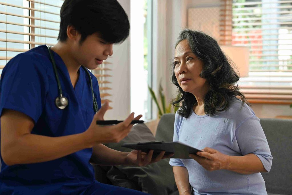 Healthcare worker explaining something to an elderly patient.