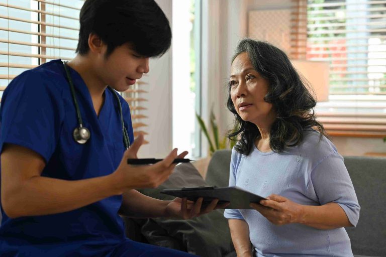 Healthcare worker explaining something to an elderly patient.