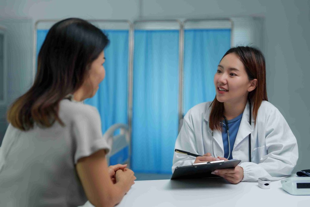 Elderly patient speaking with her doctor at the hospital.