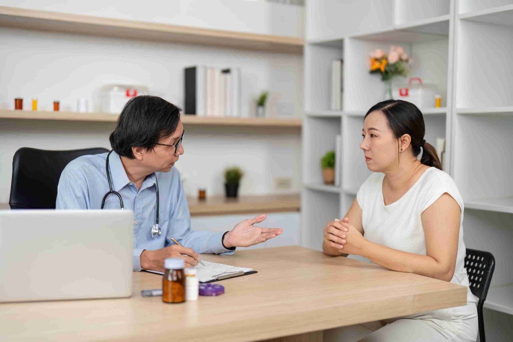 Female patient speaking with a doctor.