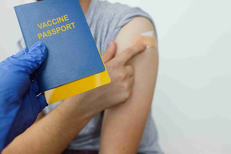 Female traveller showing off her vaccination and vaccine passport.
