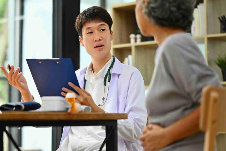 Young doctor explaining things to an elderly patient.