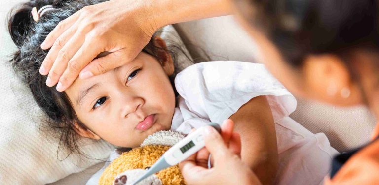 Mother checking her child's temperature.