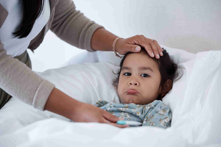 Sick toddler lying in bed and not feeling well.