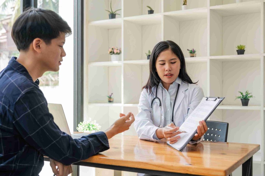 Female doctor explaining something to a patient.