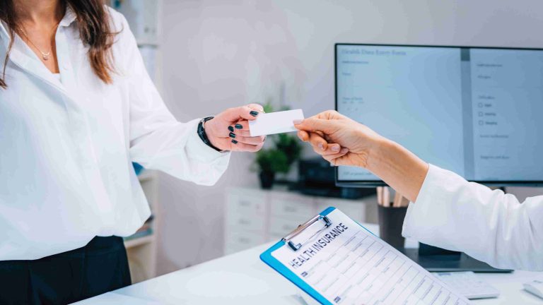 Patient handing over her CHAS card to a healthcare provider.