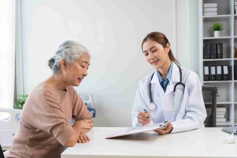 Elderly woman speaking with her doctor.