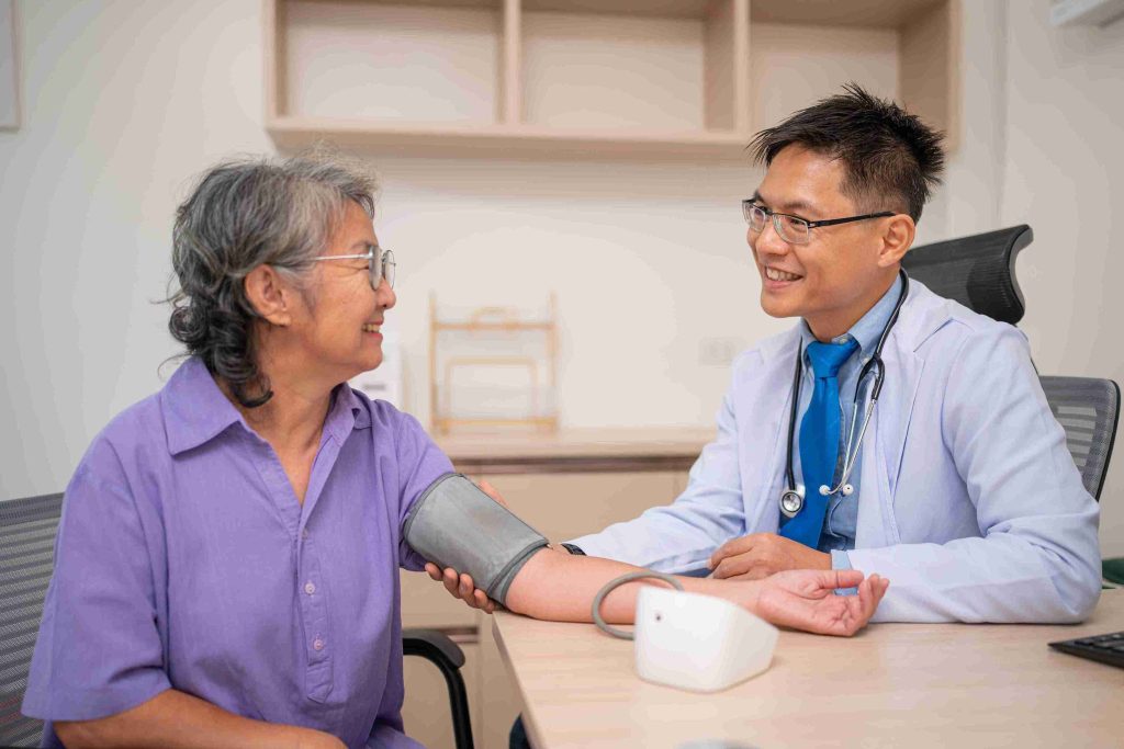 Doctor taking the blood pressure of an elderly patient.