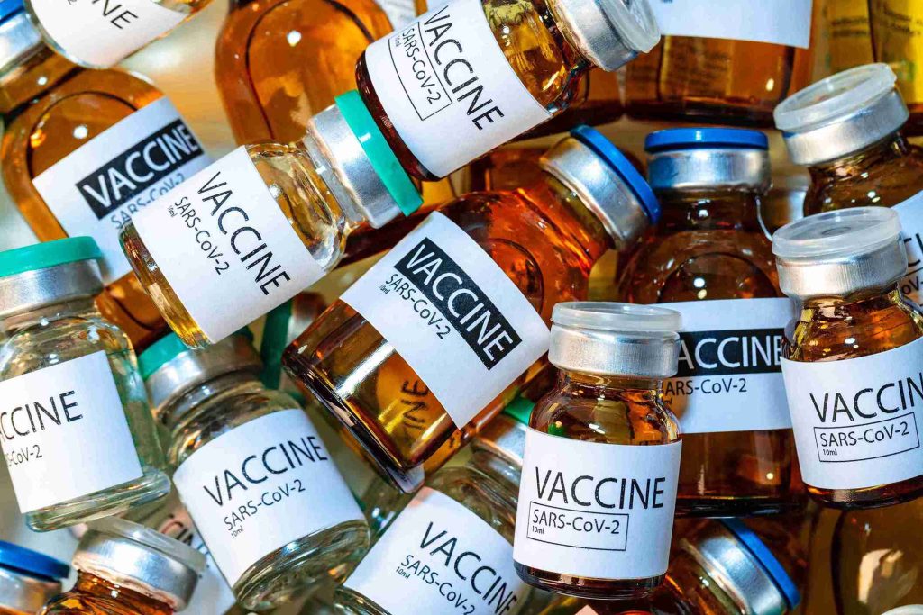 A close up image of COVID-19 vaccination vials stacked together.