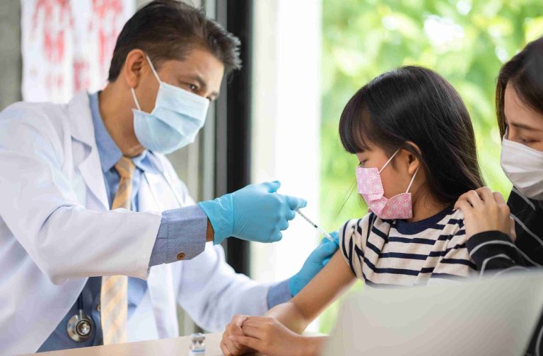 Doctor giving vaccine to a child.