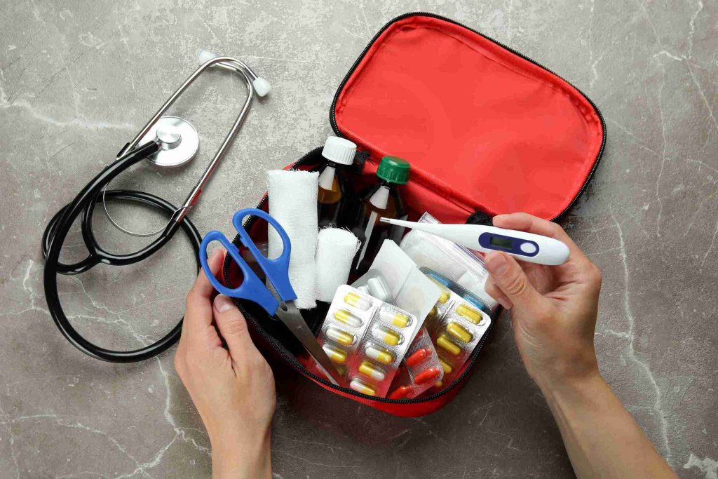 Image of a medical kits with different medications and a stethoscope next to it.